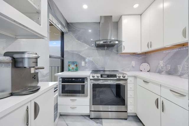 12 Royal Palm Way Unit 605, Boca Raton, FL 33432 - kitchen with stainless steel appliances, island range hood, white cabinets, light countertops, and glass insert cabinets