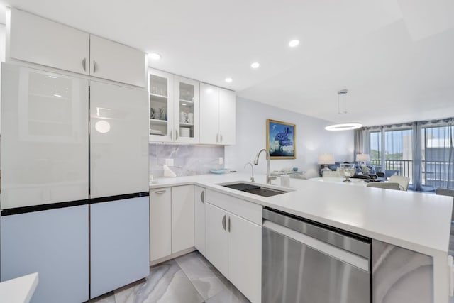 12 Royal Palm Way Unit 605, Boca Raton, FL 33432 - kitchen with stainless steel dishwasher, a sink, a peninsula, light countertops, and white cabinetry
