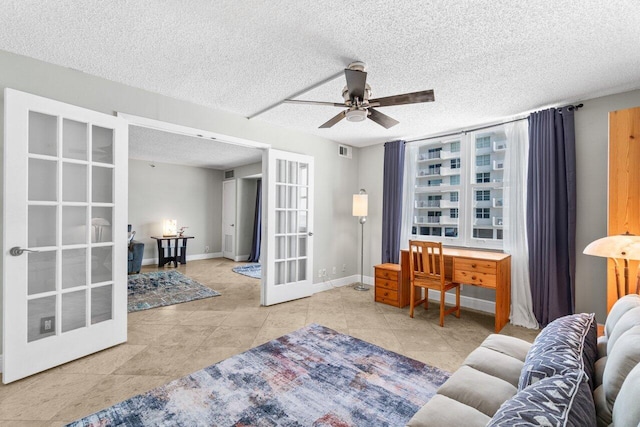 4511 S Ocean Blvd Unit 106, Highland Beach, FL 33487 - living area with french doors, a ceiling fan, a textured ceiling, and baseboards