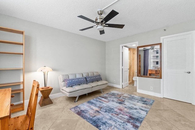 4511 S Ocean Blvd Unit 106, Highland Beach, FL 33487 - living area with ceiling fan, tile patterned floors, baseboards, and a textured ceiling