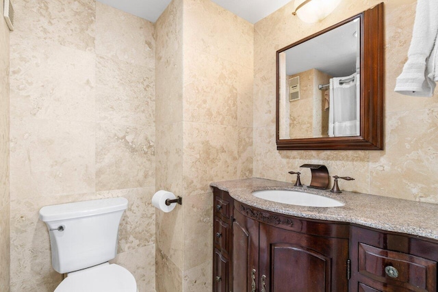4511 S Ocean Blvd Unit 106, Highland Beach, FL 33487 - bathroom featuring tile walls, vanity, and toilet