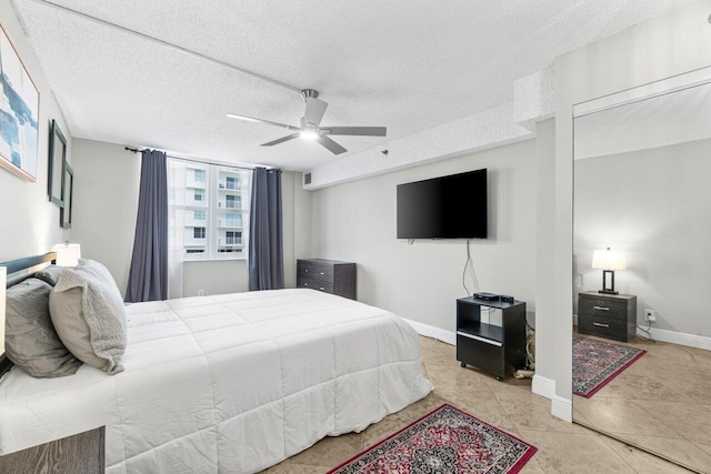 4511 S Ocean Blvd Unit 106, Highland Beach, FL 33487 - bedroom featuring a ceiling fan, baseboards, and a textured ceiling