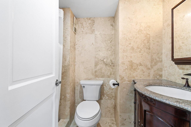 4511 S Ocean Blvd Unit 106, Highland Beach, FL 33487 - bathroom featuring vanity, toilet, and tile walls
