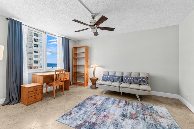 4511 S Ocean Blvd Unit 106, Highland Beach, FL 33487 - living area featuring a ceiling fan, baseboards, a textured ceiling, and light tile patterned flooring