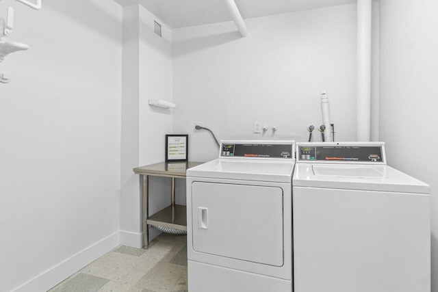 4511 S Ocean Blvd Unit 106, Highland Beach, FL 33487 - communal laundry room with separate washer and dryer and baseboards
