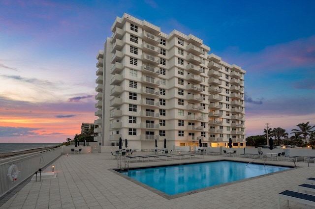 4511 S Ocean Blvd Unit 106, Highland Beach, FL 33487 - pool at dusk featuring a patio area and a community pool