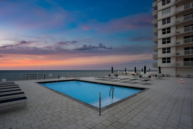 4511 S Ocean Blvd Unit 106, Highland Beach, FL 33487 - pool at dusk with a patio area, a community pool, and a water view