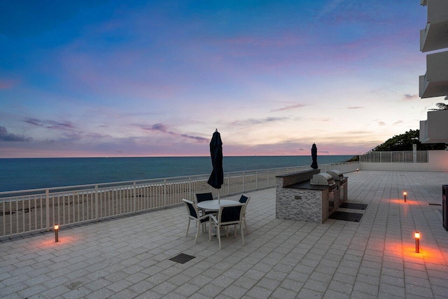 4511 S Ocean Blvd Unit 106, Highland Beach, FL 33487 - patio terrace at dusk with a water view and a patio area