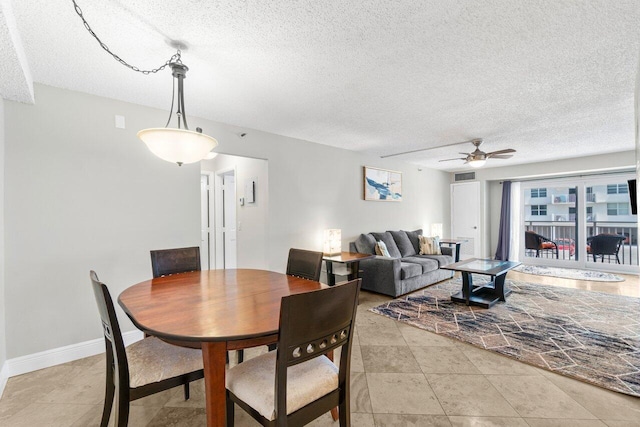 4511 S Ocean Blvd Unit 106, Highland Beach, FL 33487 - dining area with a textured ceiling, a ceiling fan, and baseboards