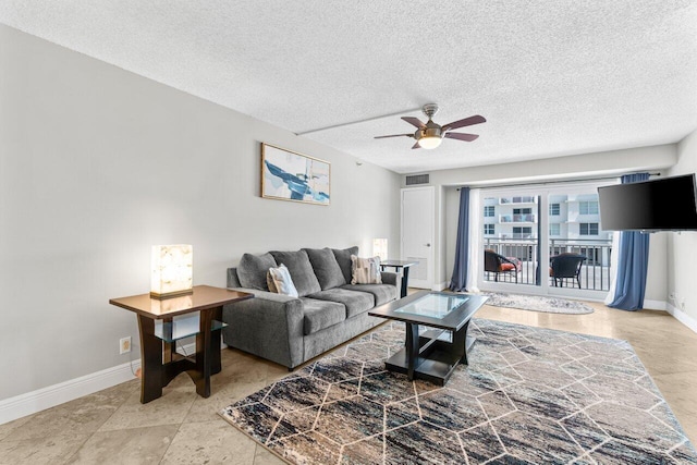 4511 S Ocean Blvd Unit 106, Highland Beach, FL 33487 - living area with baseboards, ceiling fan, and a textured ceiling