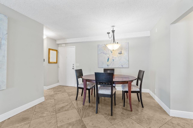4511 S Ocean Blvd Unit 106, Highland Beach, FL 33487 - dining area featuring a textured ceiling, light tile patterned flooring, and baseboards