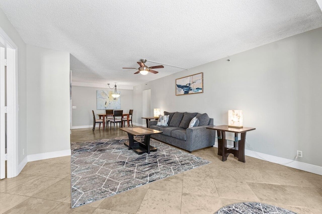 4511 S Ocean Blvd Unit 106, Highland Beach, FL 33487 - tiled living area with ceiling fan, a textured ceiling, and baseboards