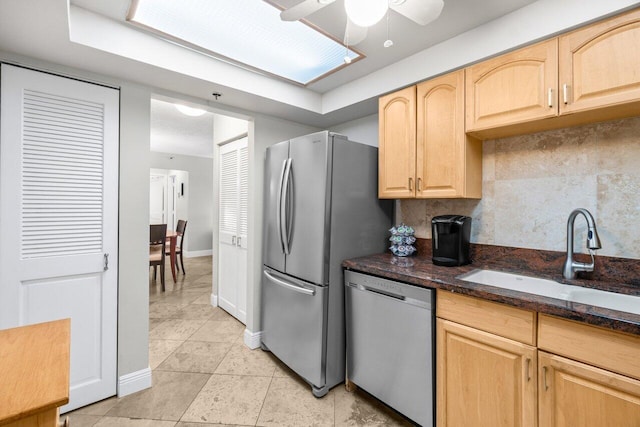 4511 S Ocean Blvd Unit 106, Highland Beach, FL 33487 - kitchen with stainless steel appliances, a sink, light brown cabinetry, light tile patterned floors, and ceiling fan