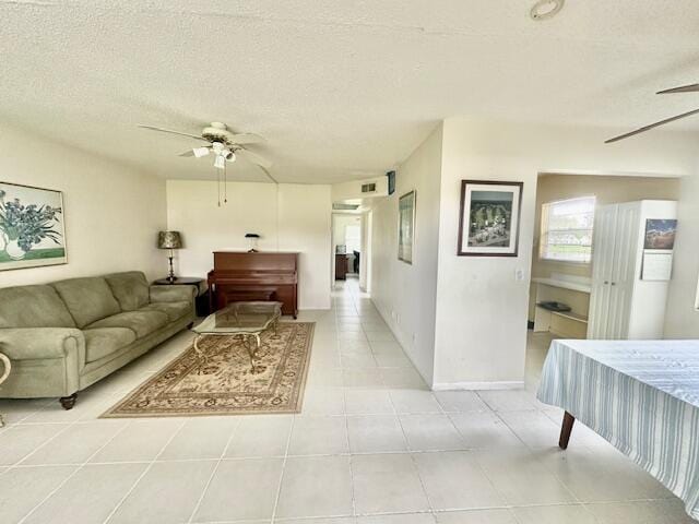 130 Brighton D, Boca Raton, FL 33434 - living room with a ceiling fan, light tile patterned flooring, a textured ceiling, and baseboards