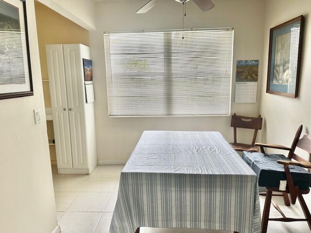 130 Brighton D, Boca Raton, FL 33434 - tiled dining space featuring a ceiling fan
