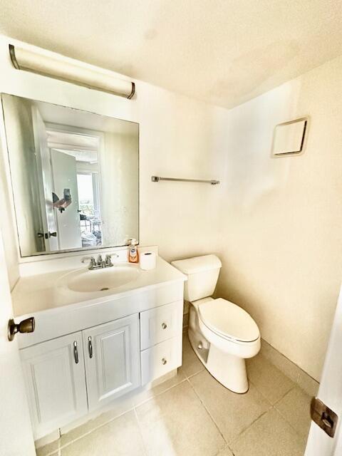 130 Brighton D, Boca Raton, FL 33434 - bathroom featuring toilet, vanity, and tile patterned floors