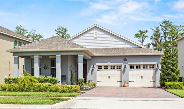 17936 Adrift Rd, Winter Garden, FL 34787 - view of front of property with an attached garage, roof with shingles, decorative driveway, and stucco siding