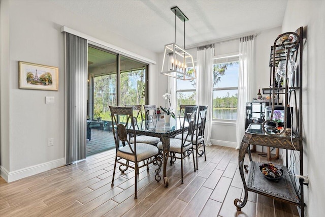 17936 Adrift Rd, Winter Garden, FL 34787 - dining area with baseboards and light wood-style flooring