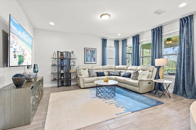 17936 Adrift Rd, Winter Garden, FL 34787 - living area featuring light wood finished floors, baseboards, recessed lighting, and a textured ceiling