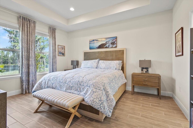 17936 Adrift Rd, Winter Garden, FL 34787 - bedroom featuring baseboards, wood tiled floors, recessed lighting, and a tray ceiling