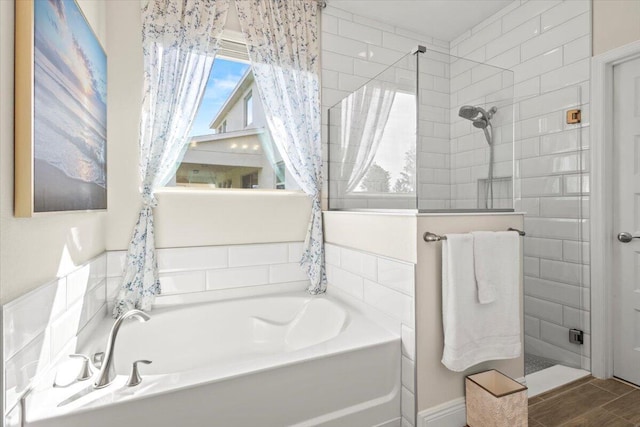 17936 Adrift Rd, Winter Garden, FL 34787 - full bathroom with a bath, a tile shower, and wood finished floors
