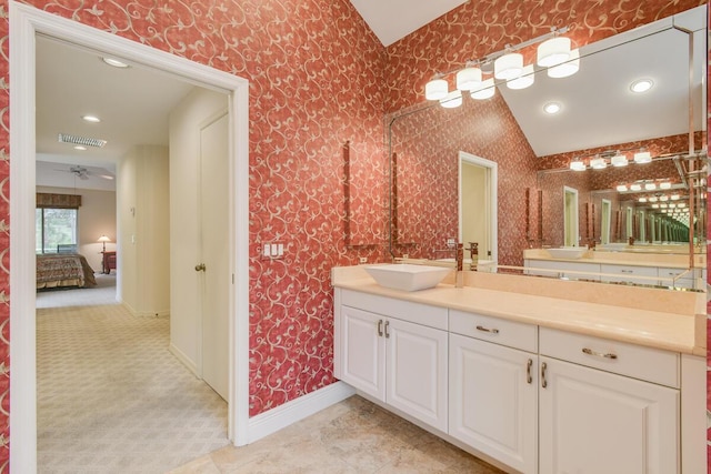 13312 NW Maplewood Rd, Palm City, FL 34990 - ensuite bathroom with vanity, wallpapered walls, baseboards, recessed lighting, and vaulted ceiling