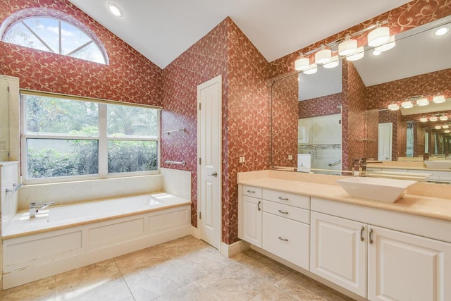 13312 NW Maplewood Rd, Palm City, FL 34990 - bathroom featuring lofted ceiling, a garden tub, vanity, tiled shower, and recessed lighting