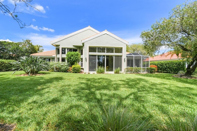 13312 NW Maplewood Rd, Palm City, FL 34990 - rear view of property featuring a yard, stucco siding, and a sunroom