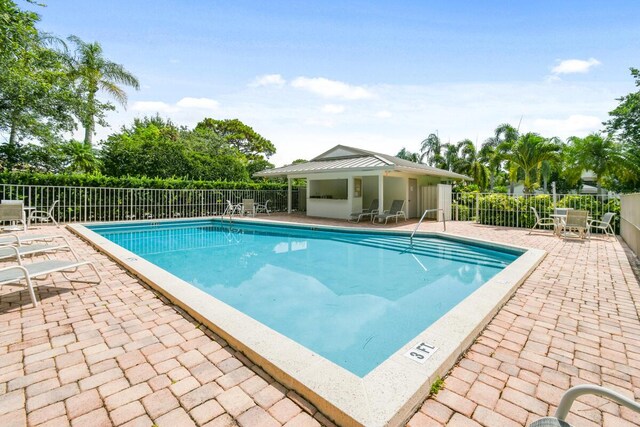 13312 NW Maplewood Rd, Palm City, FL 34990 - community pool with a patio