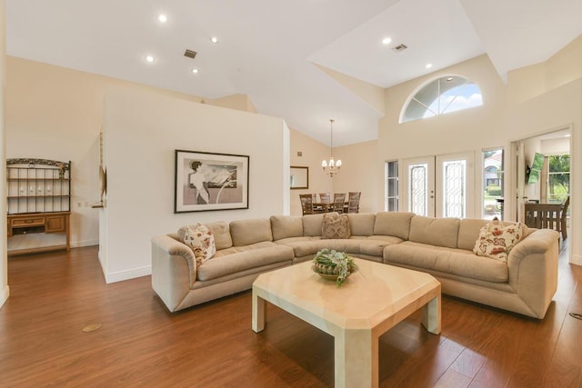 13312 NW Maplewood Rd, Palm City, FL 34990 - living room with wood finished floors, a chandelier, recessed lighting, baseboards, and high vaulted ceiling