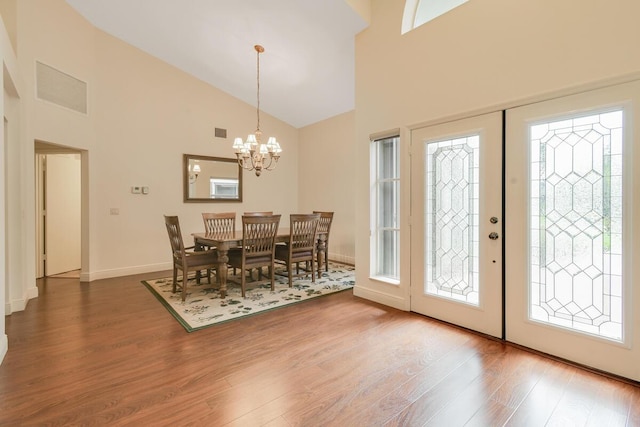 13312 NW Maplewood Rd, Palm City, FL 34990 - dining space with high vaulted ceiling, wood finished floors, a chandelier, and baseboards