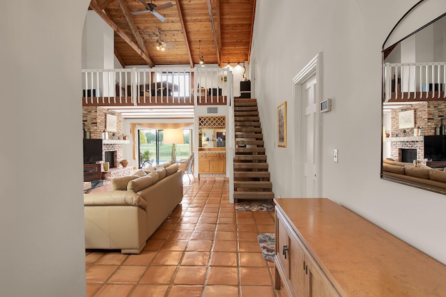 5898 Vista Linda Ln, Boca Raton, FL 33433 - living room featuring a brick fireplace, wood ceiling with exposed beams, high vaulted ceiling, ceiling fan, and stairs