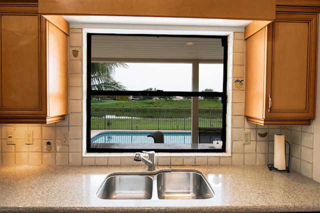 5898 Vista Linda Ln, Boca Raton, FL 33433 - kitchen with a sink, tasteful backsplash, light countertops, and brown cabinetry