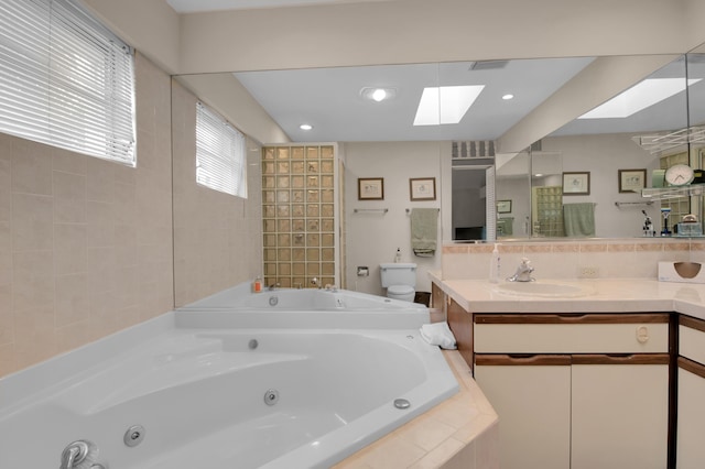 5898 Vista Linda Ln, Boca Raton, FL 33433 - full bathroom with a skylight, a jetted tub, vanity, toilet, and decorative backsplash