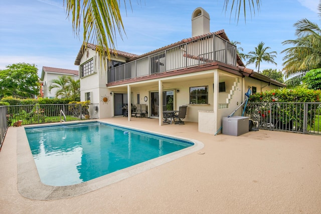 5898 Vista Linda Ln, Boca Raton, FL 33433 - back of property featuring a balcony, stucco siding, a patio area, and a chimney