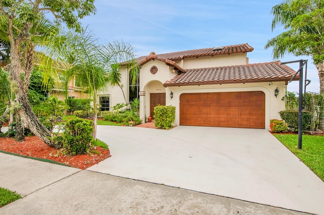 5898 Vista Linda Ln, Boca Raton, FL 33433 - mediterranean / spanish house featuring an attached garage, stucco siding, driveway, and a tile roof