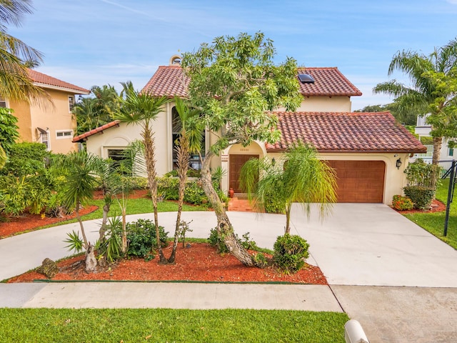 5898 Vista Linda Ln, Boca Raton, FL 33433 - mediterranean / spanish house with a tile roof, stucco siding, driveway, and an attached garage