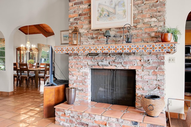 5898 Vista Linda Ln, Boca Raton, FL 33433 - detailed view of arched walkways, range, a chandelier, and a fireplace with raised hearth