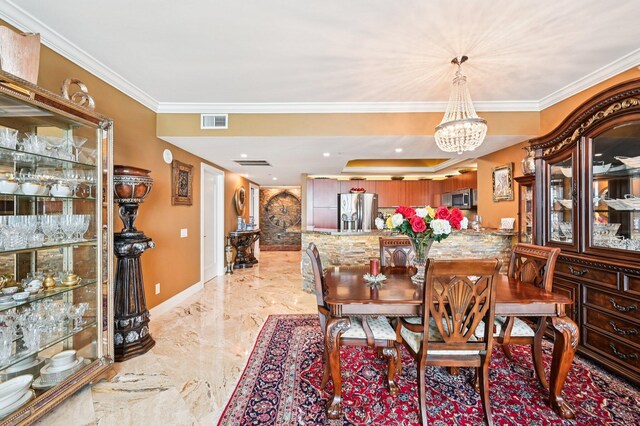 2640 Lake Shore Dr Unit 1510, Riviera Beach, FL 33404 - dining space featuring a chandelier, crown molding, light marble finish flooring, and baseboards