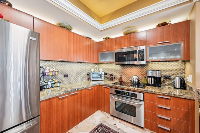 2640 Lake Shore Dr Unit 1510, Riviera Beach, FL 33404 - kitchen featuring appliances with stainless steel finishes, glass insert cabinets, backsplash, and light stone countertops