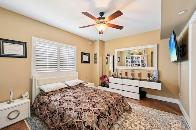 2640 Lake Shore Dr Unit 1510, Riviera Beach, FL 33404 - bedroom featuring wood finished floors, baseboards, and ceiling fan