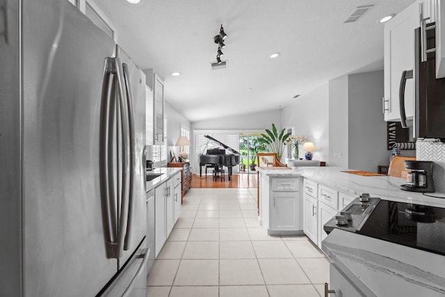 649 Hudson Bay Dr, Palm Beach Gardens, FL 33410 - kitchen with stainless steel refrigerator with ice dispenser, a peninsula, white cabinetry, light stone countertops, and open floor plan