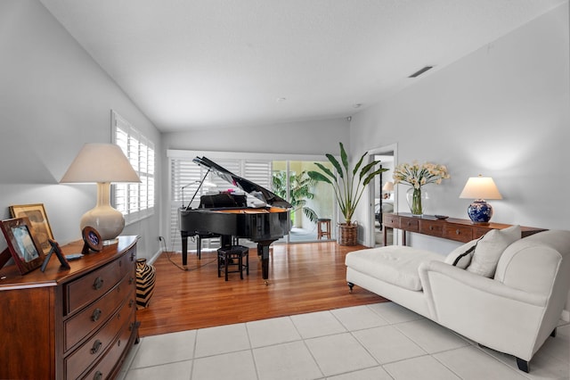 649 Hudson Bay Dr, Palm Beach Gardens, FL 33410 - living room featuring lofted ceiling and light tile patterned flooring