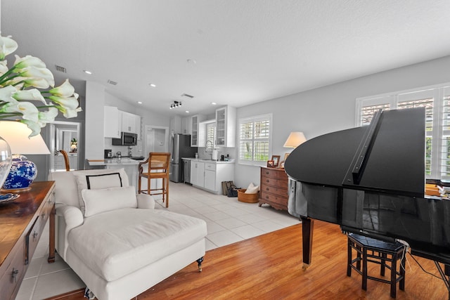 649 Hudson Bay Dr, Palm Beach Gardens, FL 33410 - living area with recessed lighting, vaulted ceiling, and light tile patterned floors