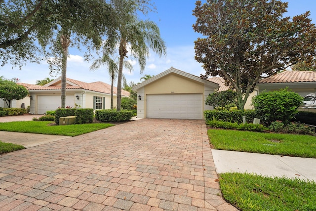 649 Hudson Bay Dr, Palm Beach Gardens, FL 33410 - view of front of house with decorative driveway, an attached garage, and stucco siding