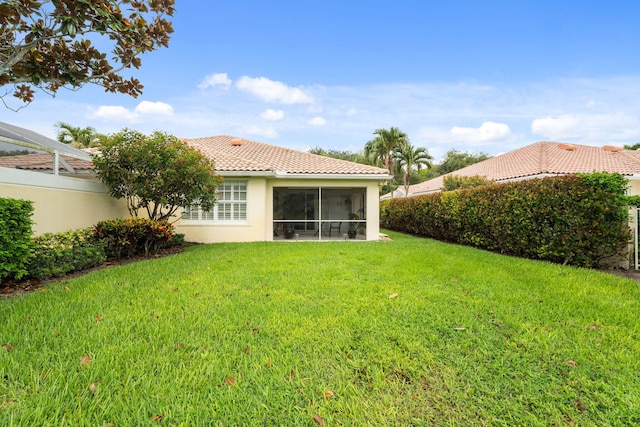 649 Hudson Bay Dr, Palm Beach Gardens, FL 33410 - back of property featuring stucco siding, a lawn, a tiled roof, and a sunroom