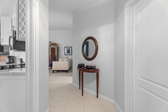 649 Hudson Bay Dr, Palm Beach Gardens, FL 33410 - hallway featuring light tile patterned floors and baseboards
