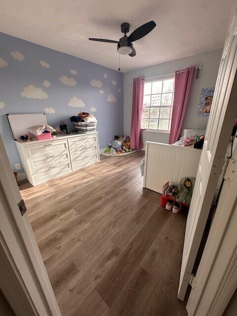 9202 Olmstead Dr, Lake Worth, FL 33467 - bedroom featuring wood finished floors, a ceiling fan, and radiator