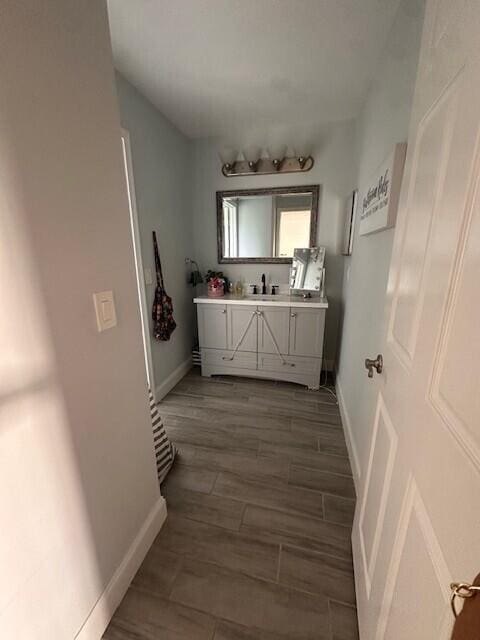 9202 Olmstead Dr, Lake Worth, FL 33467 - bathroom featuring vanity, baseboards, and wood finished floors