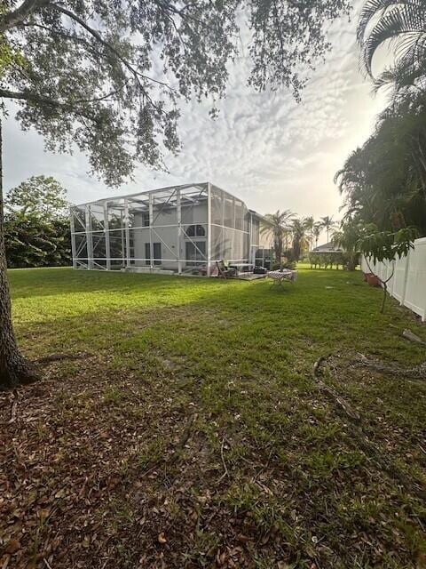 9202 Olmstead Dr, Lake Worth, FL 33467 - view of grassy yard featuring glass enclosure